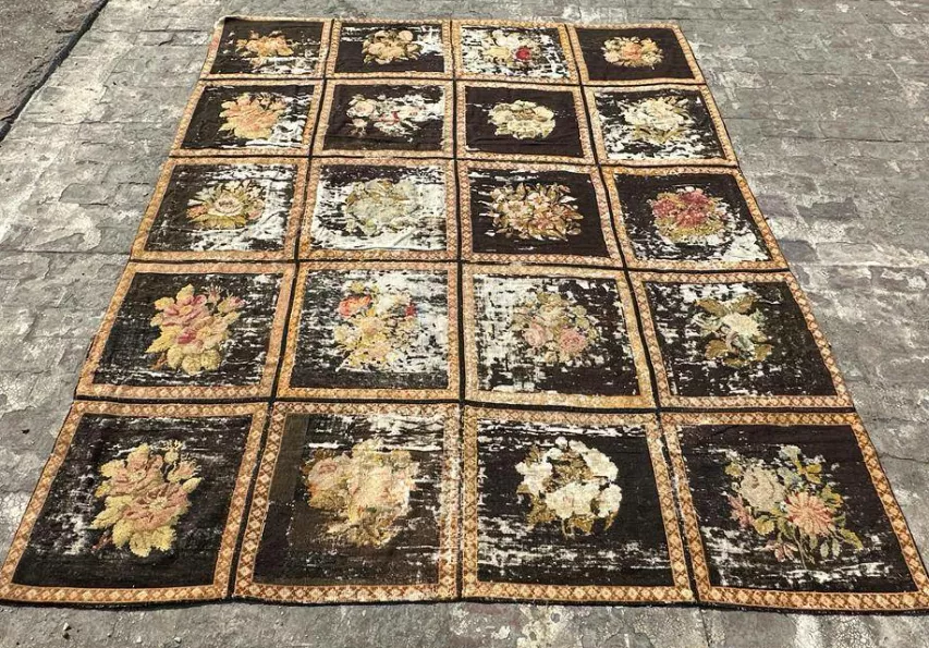 Before restoration: damaged rug showing wear, stains, and structural issues