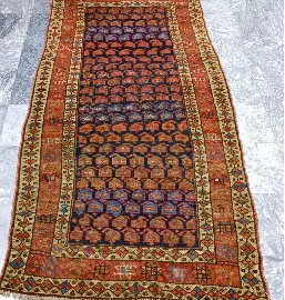 After restoration: beautifully restored vintage patterned rug with vibrant colors and clear patterns